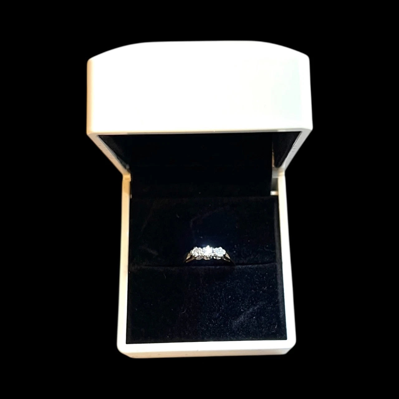 Diamond ring in a white box on a black background
