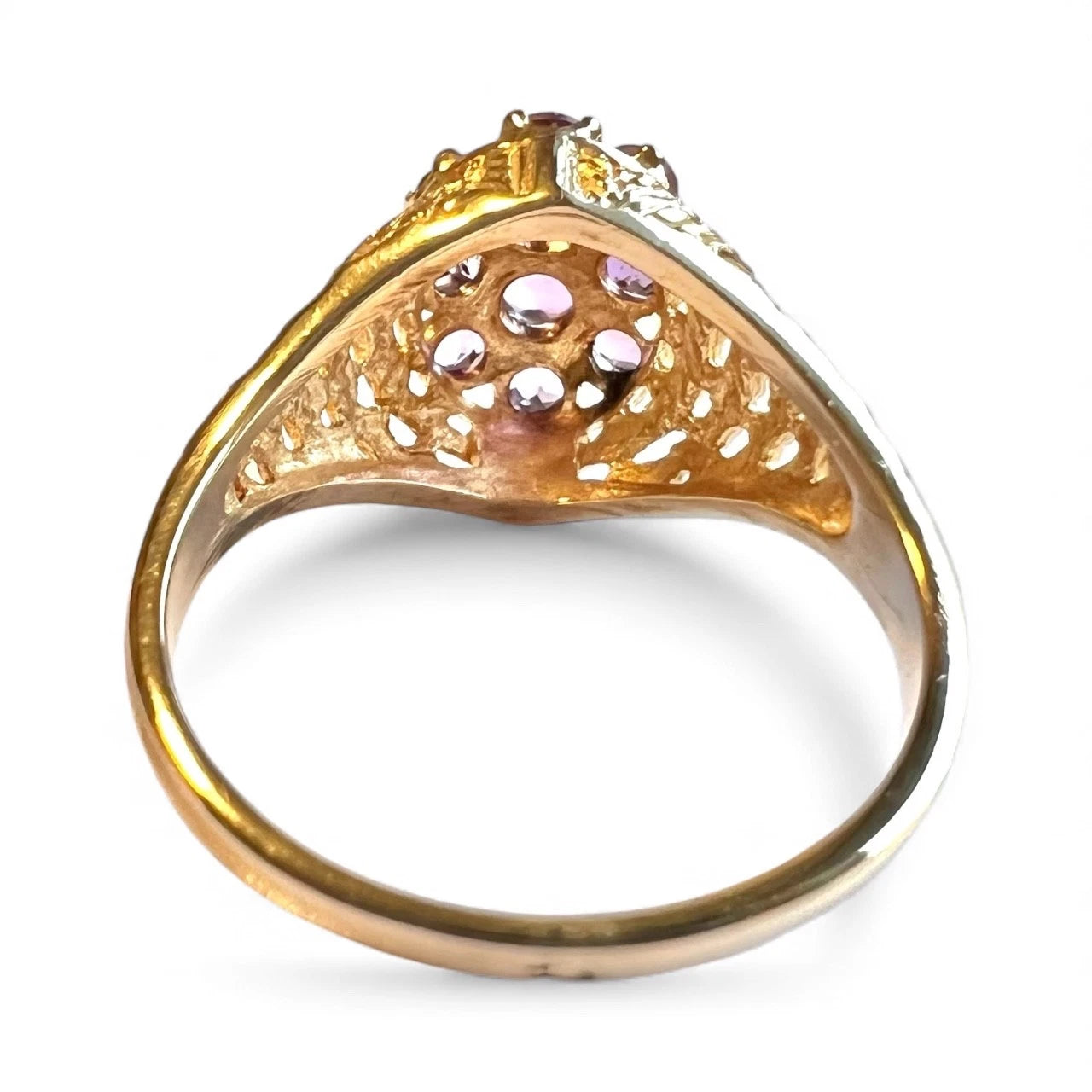 Gold ring with gemstones on a white background