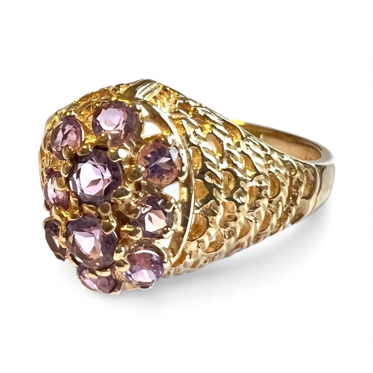 Close Up gold ring with purple amethyst gemstones on a white background