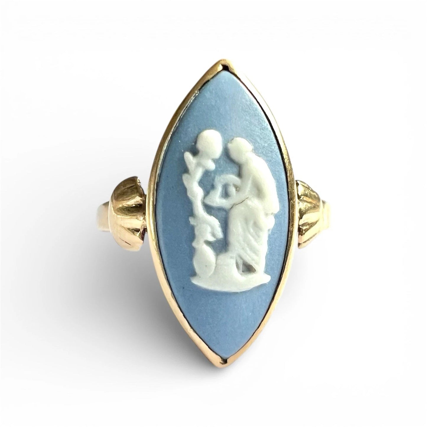 Ring with a blue stone featuring a white cameo design on a white background