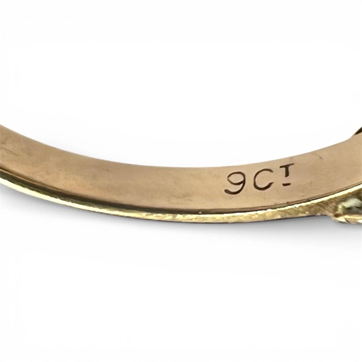 Gold ring with '9ct' marking on a white background