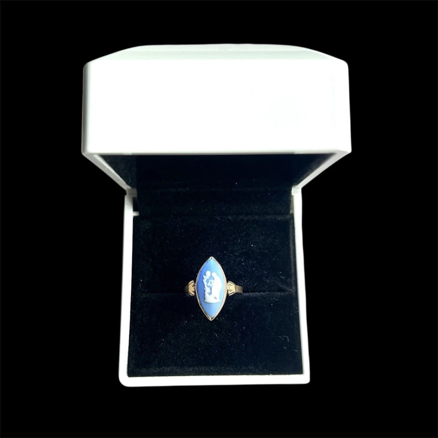 Blue cameo Ring with in a white box on a black background