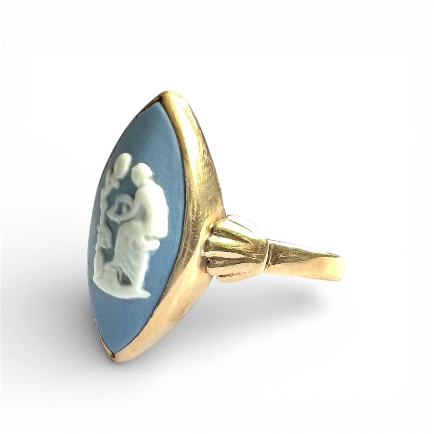 Jewellery with blue stone and gold setting on a white background