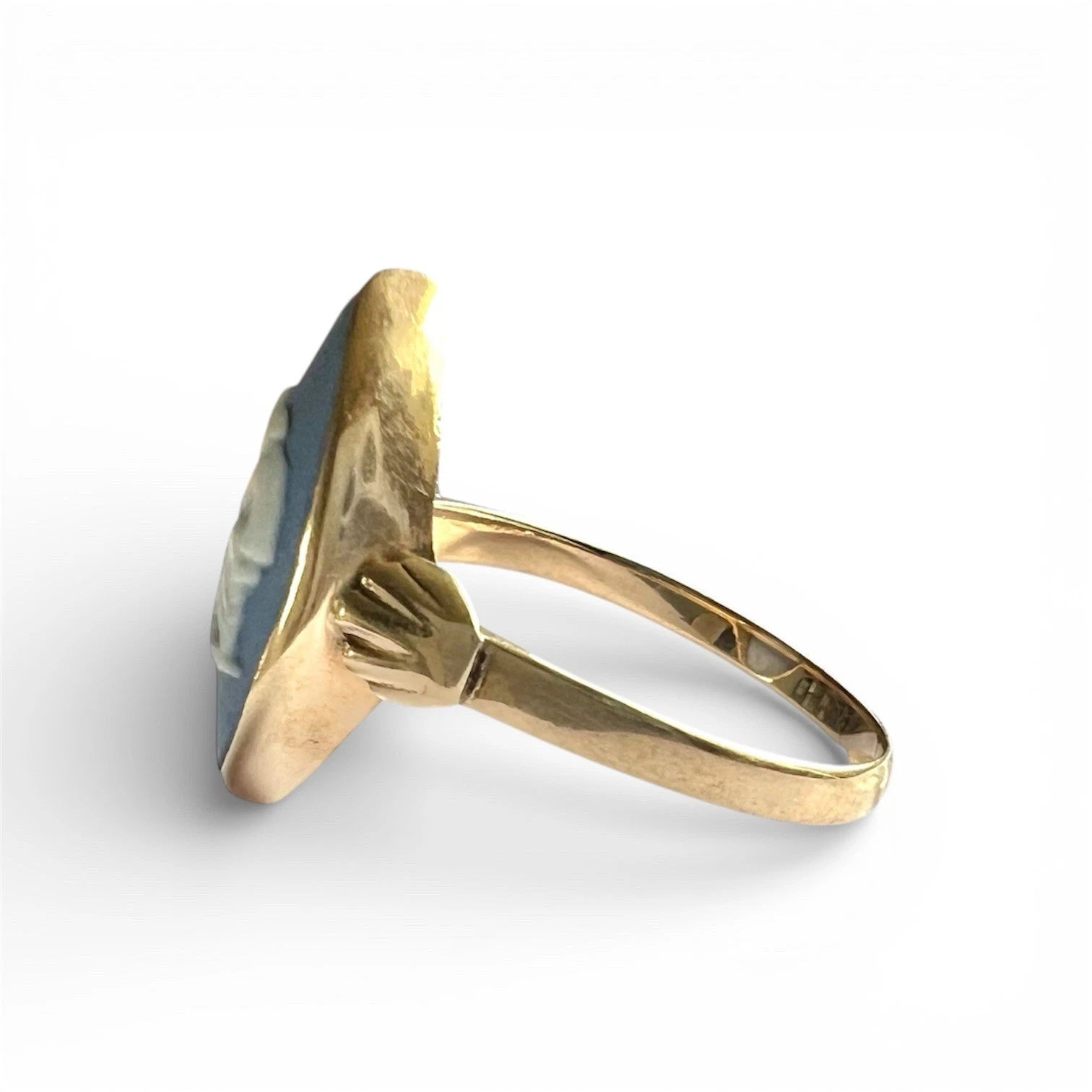 Gold ring with a blue stone on a white background