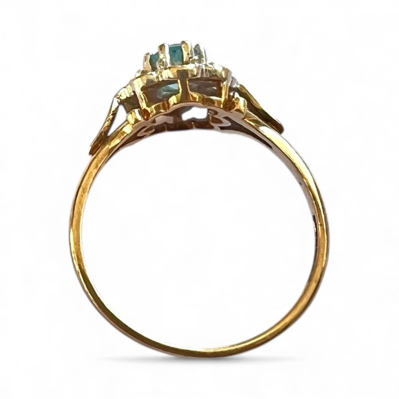 Gold ring with gemstones on a white background