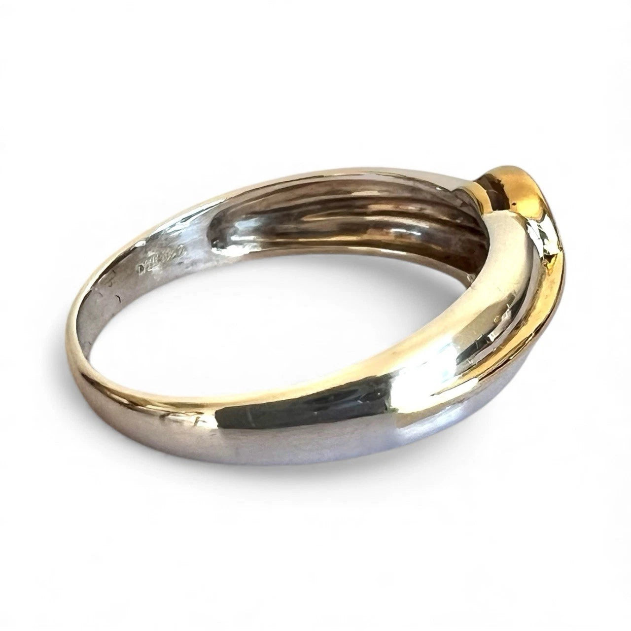 Two-tone gold and white gold ring on a white background