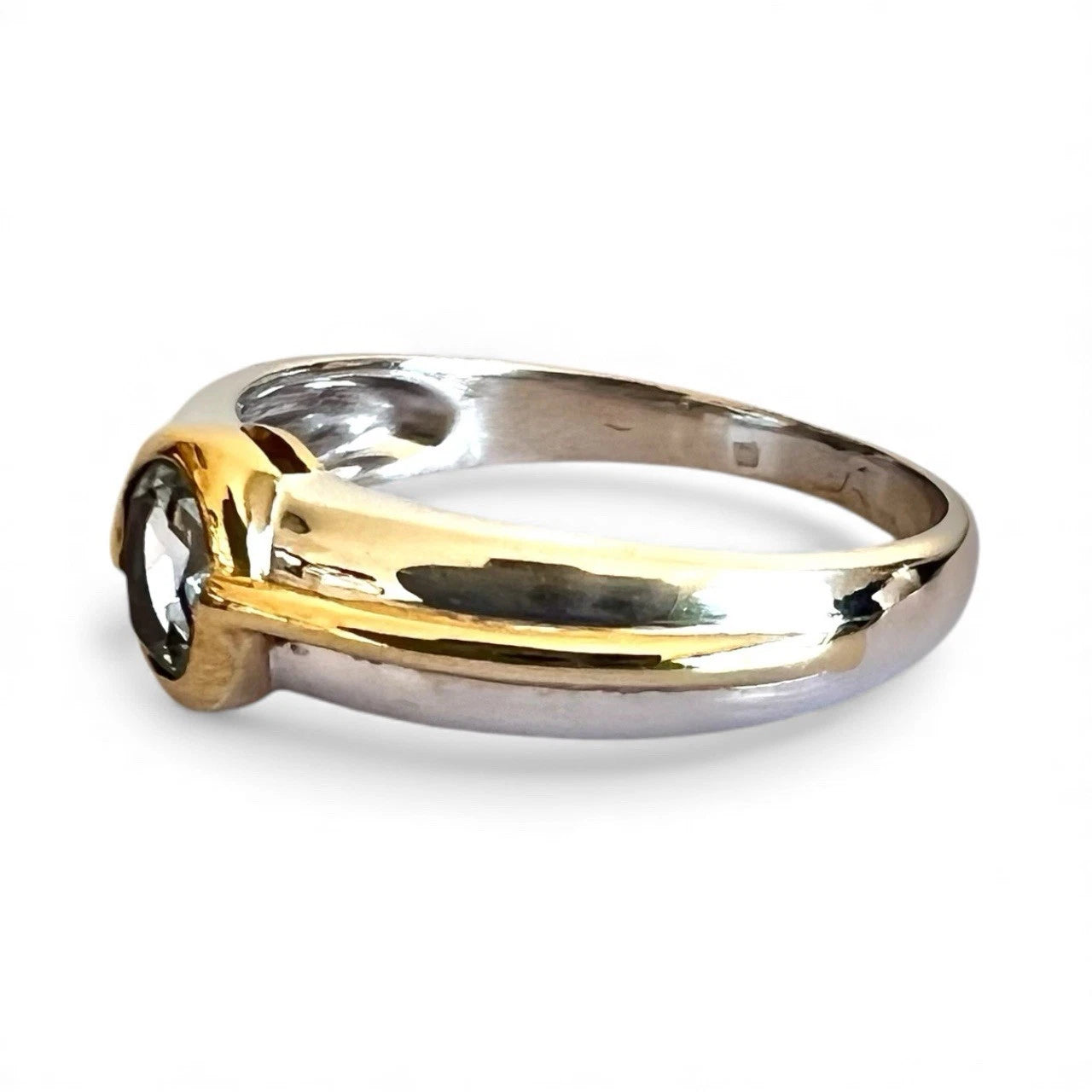Two-tone gold and white gold ring on a white background