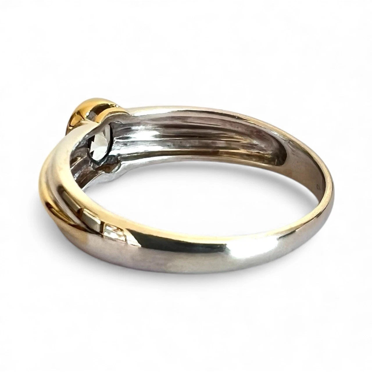 Two-toned gold and white gold ring on a white background