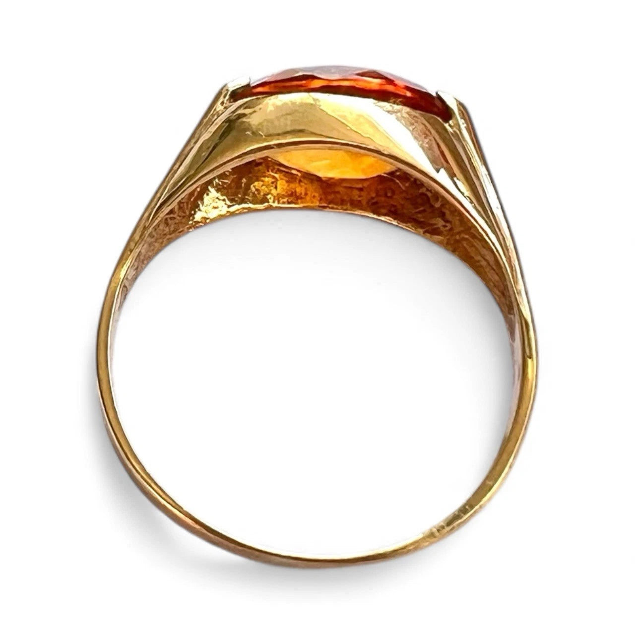 Gold ring with a large citrine stone on a white background
