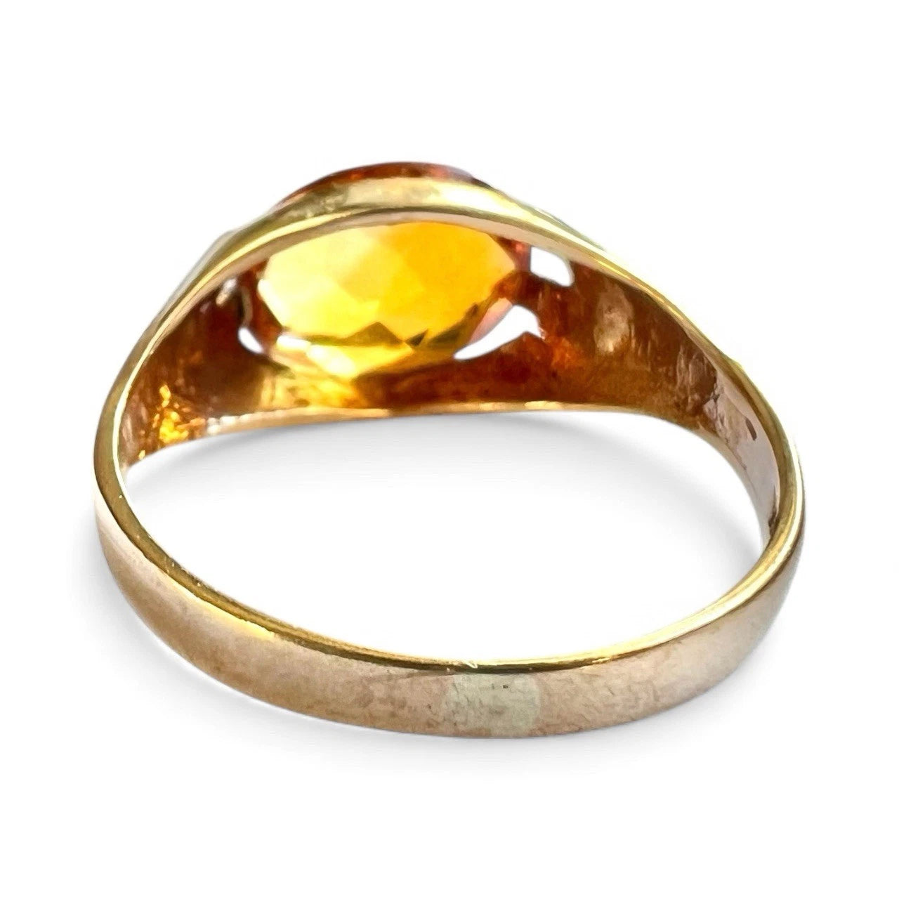 Gold ring with a large citrine stone on a white background rear view 