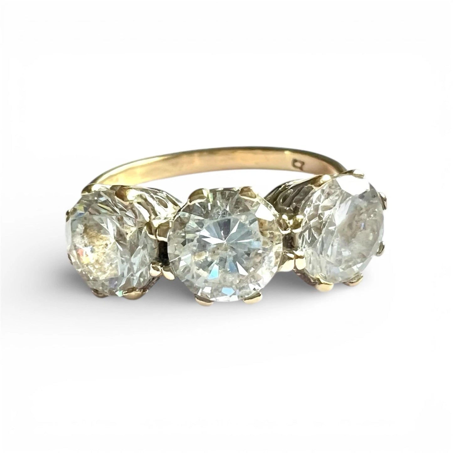Gold ring with three large CZ on a white background