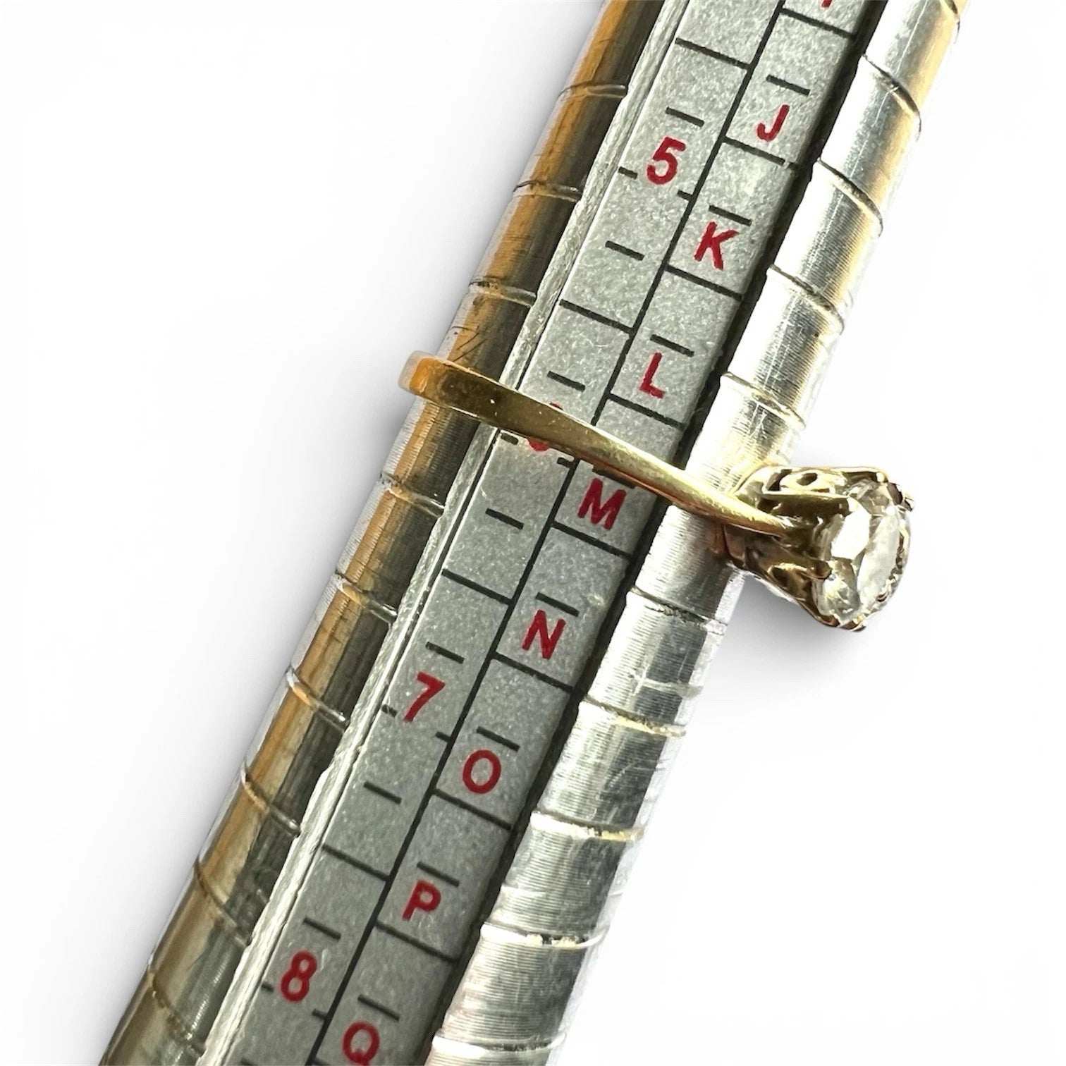Diamond ring on a ring sizer gauge with showing ring size.