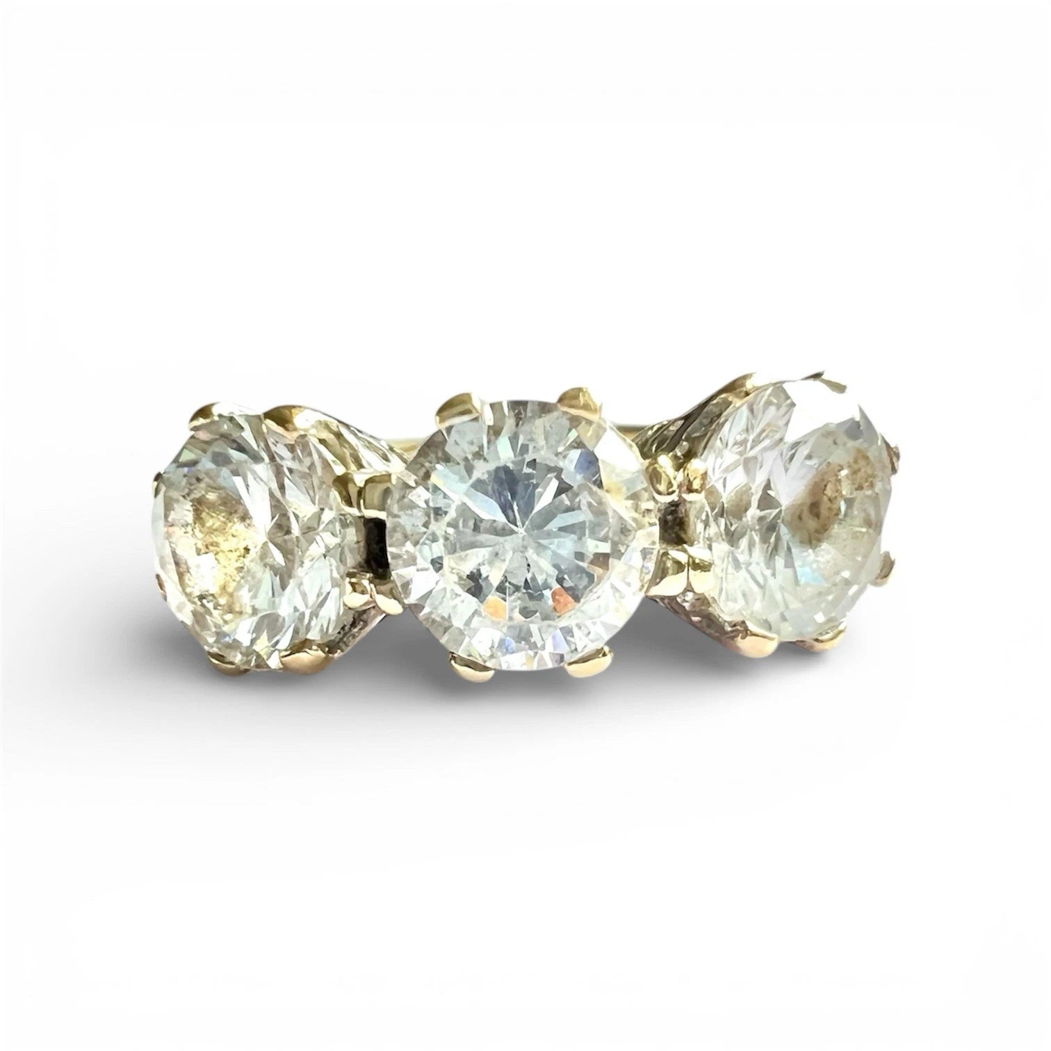 Close up of three stone CZ ring on a white background