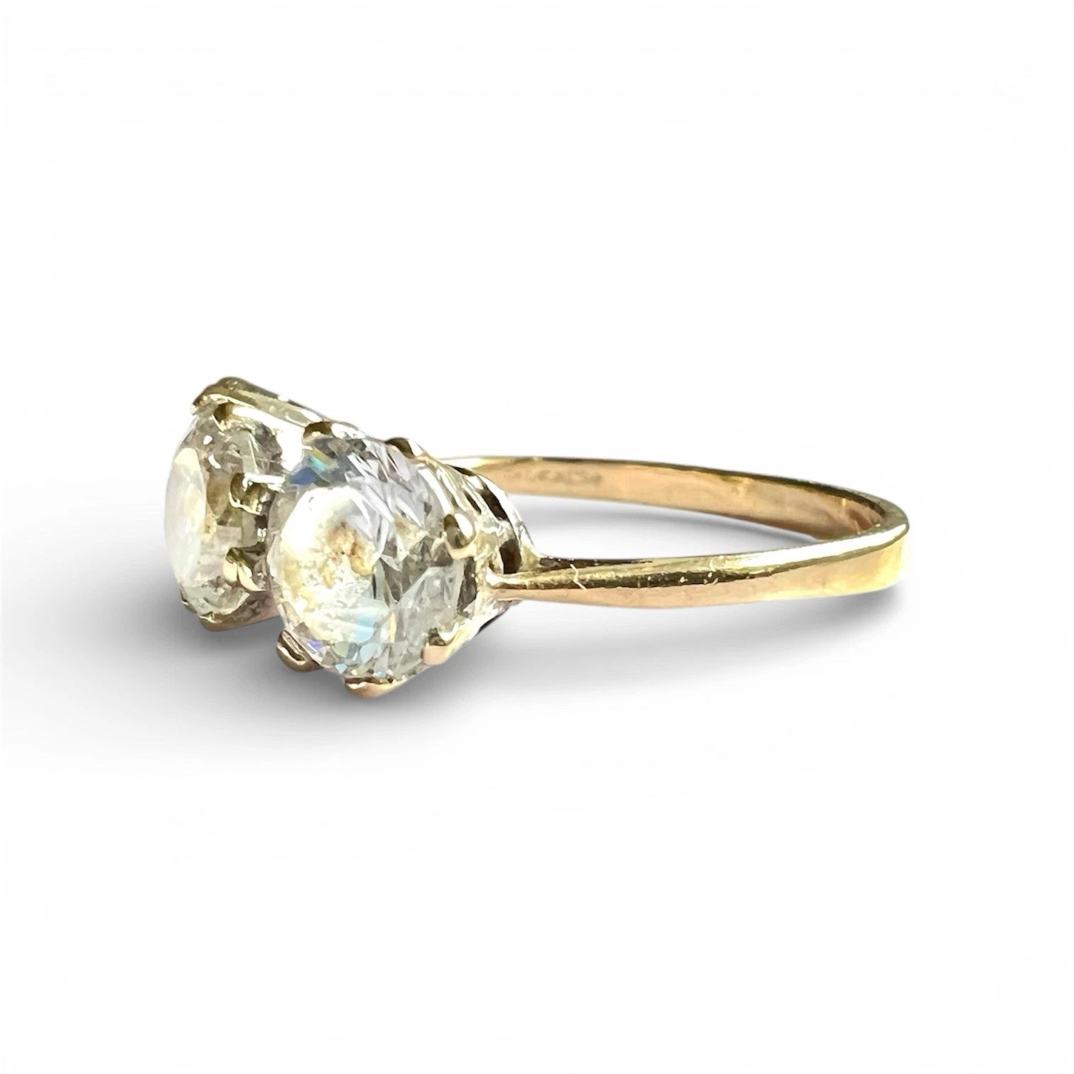 Gold ring with three cz gemstones on a white background