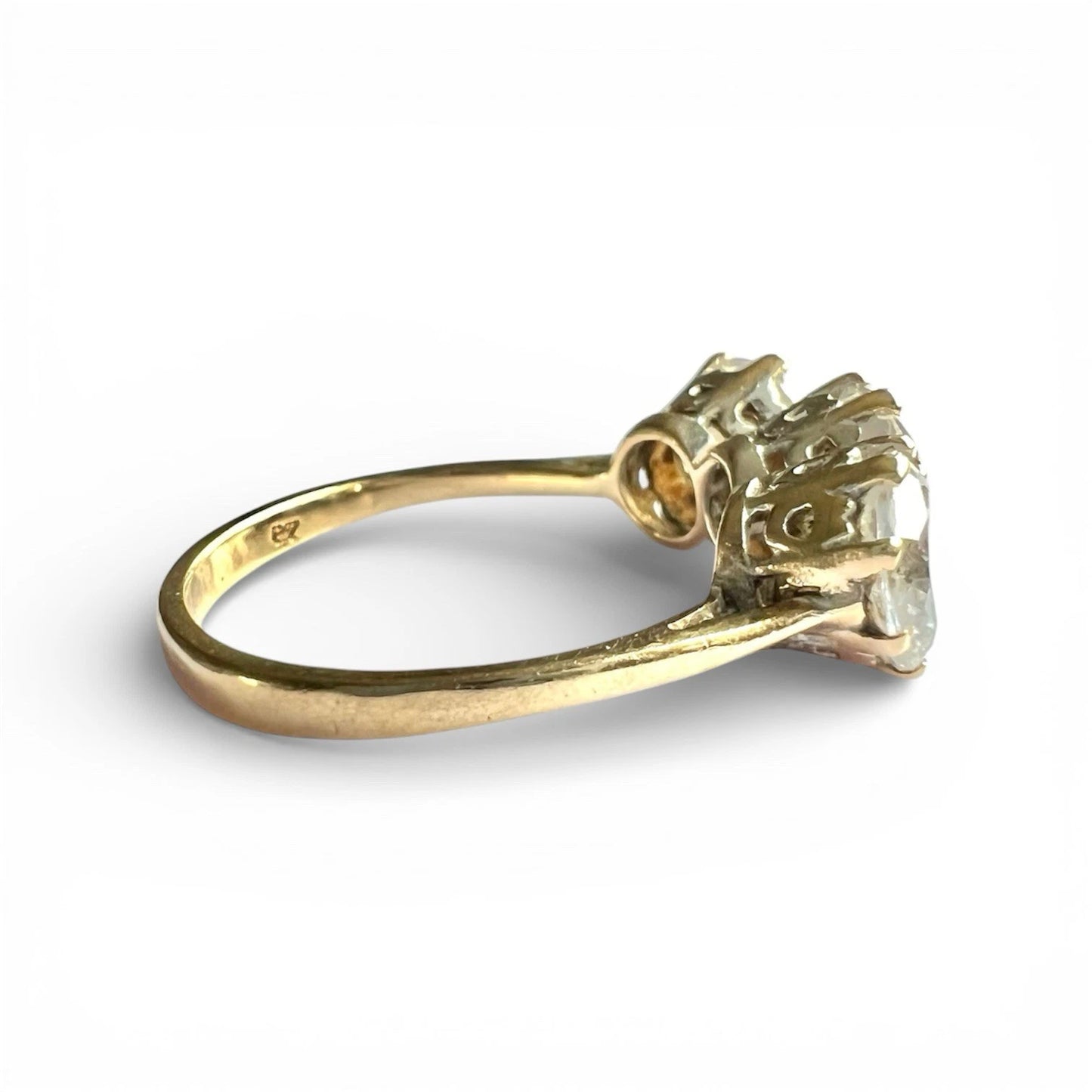 Close up gold ring with three CZ on a white background