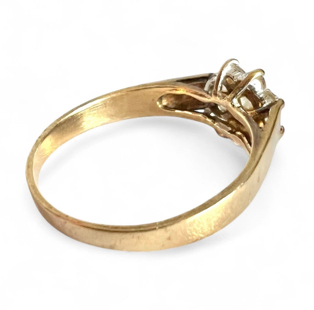 Gold ring with a cubic zirconia on a white background