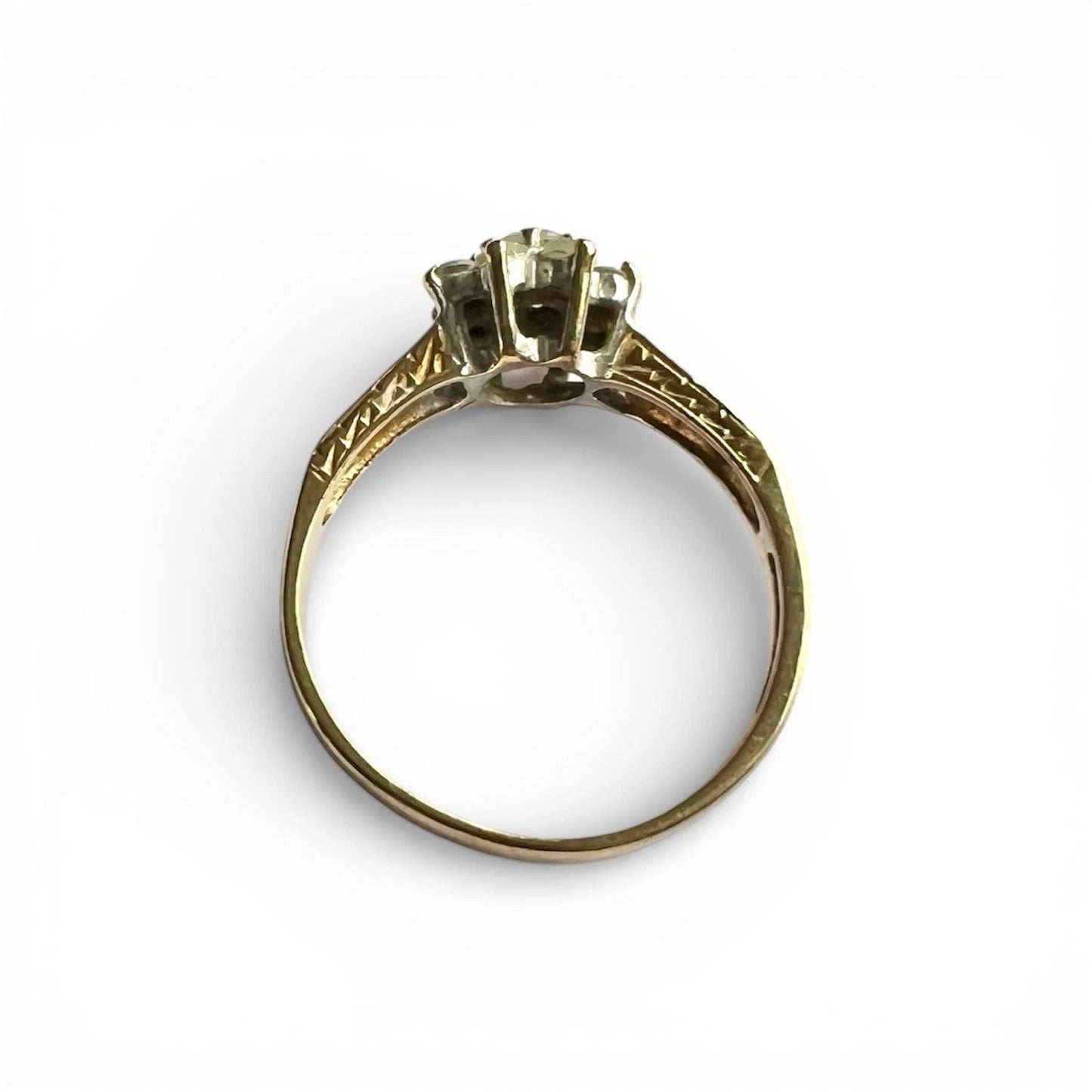 Gold ring with a central gemstone on a white background top down view 
