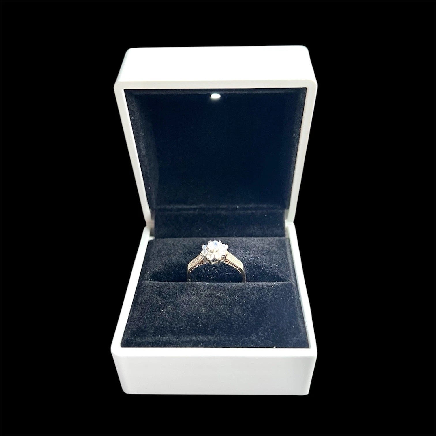 Cubic zirconia ring in a white box with a black background
