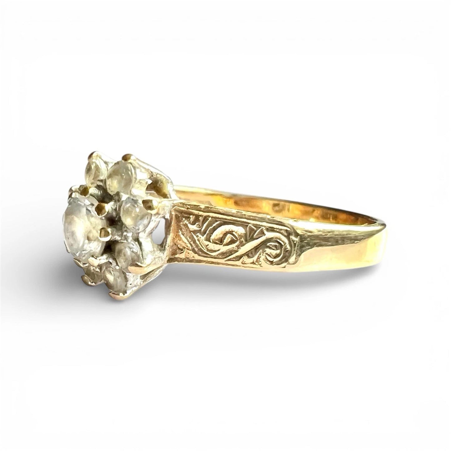 Gold ring with a decorative band on a white background
