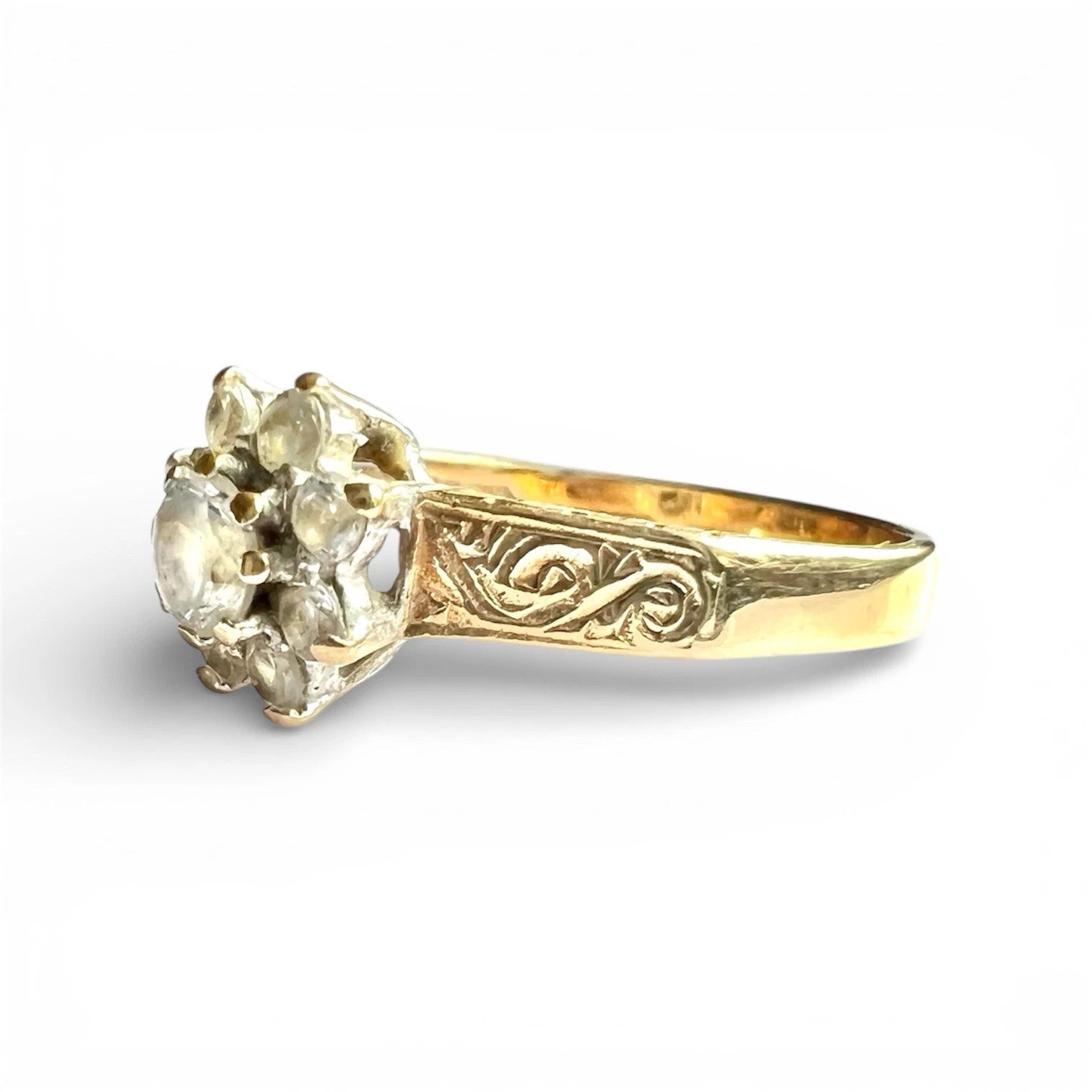 Gold ring with a decorative band on a white background