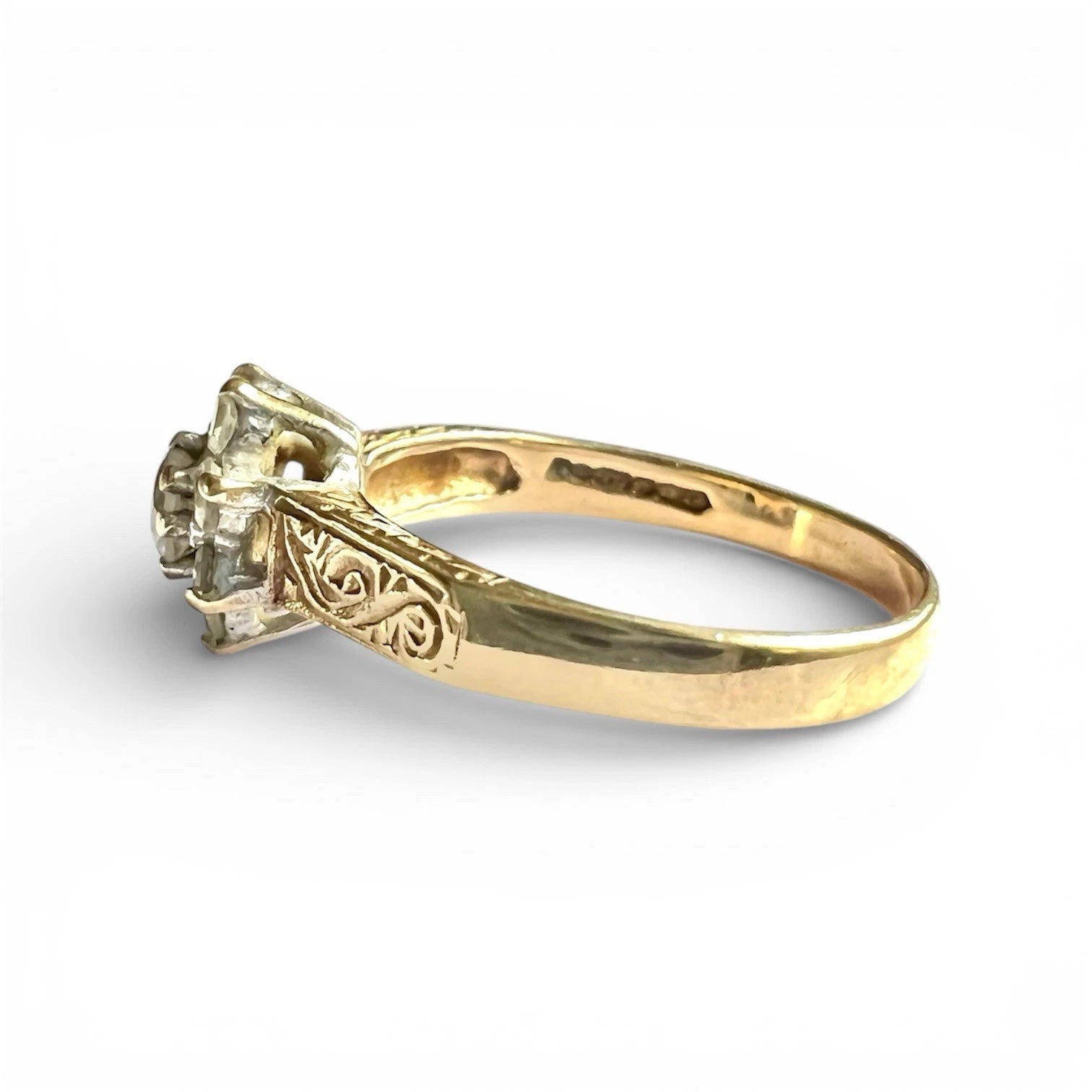 Gold ring with cubic zirconia on a white background