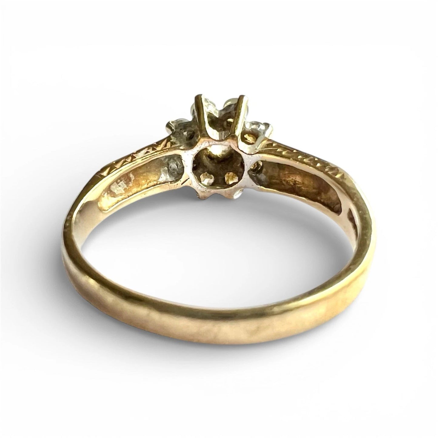 Gold ring with cubic zirconia on a white background