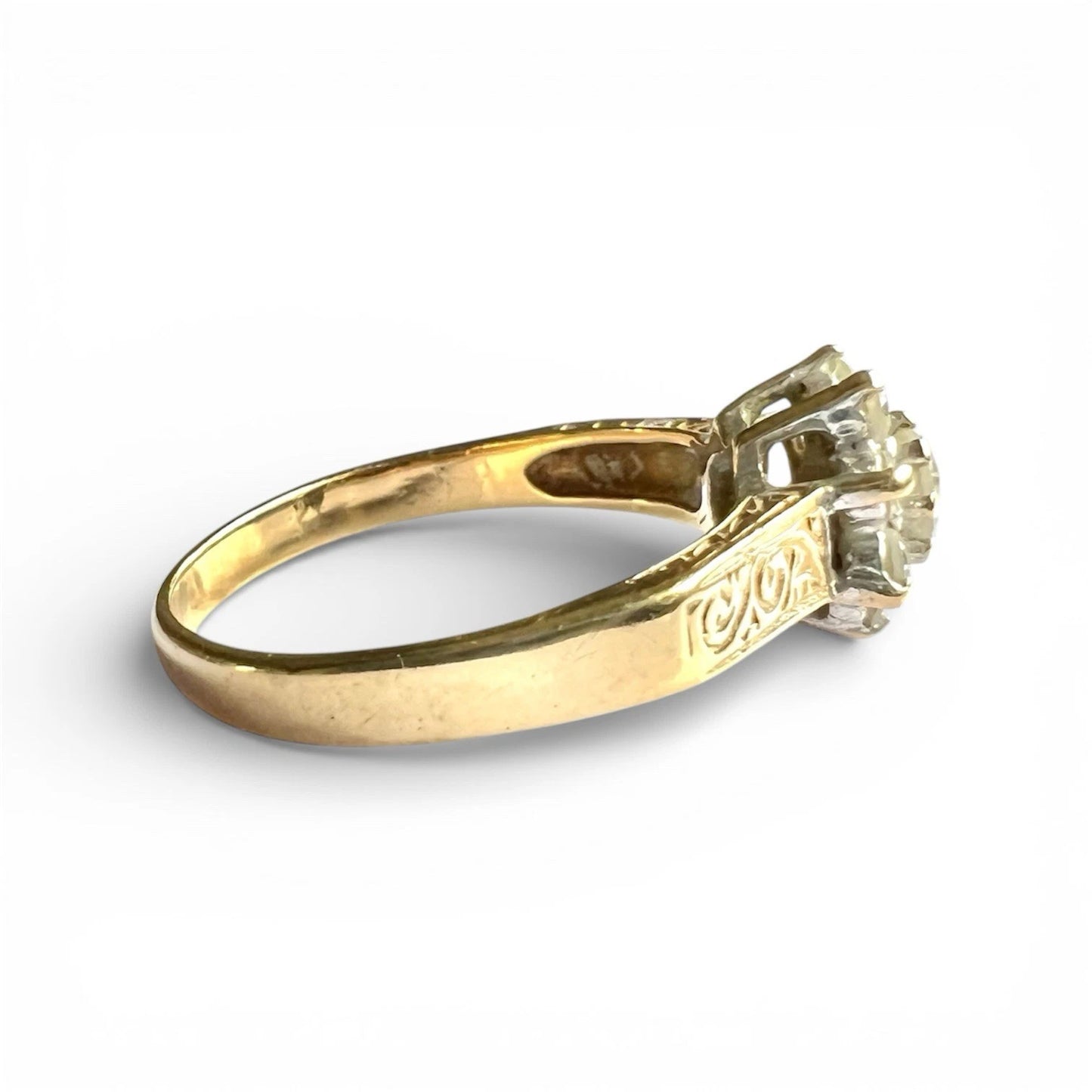 Gold ring with a cubic zirconia flower cluster on a white background