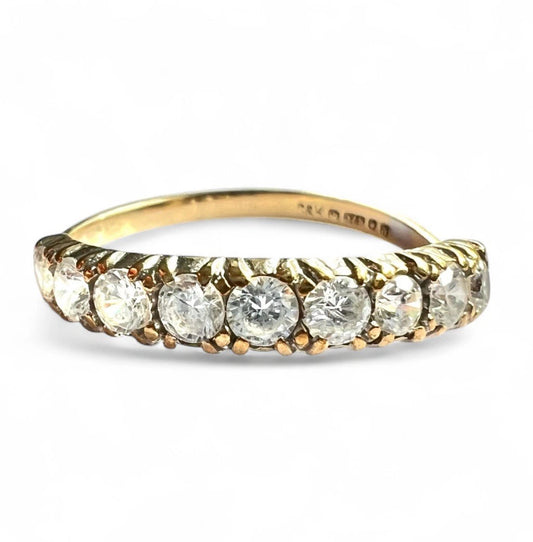 Gold ring with Cubic Zirconia on a white background