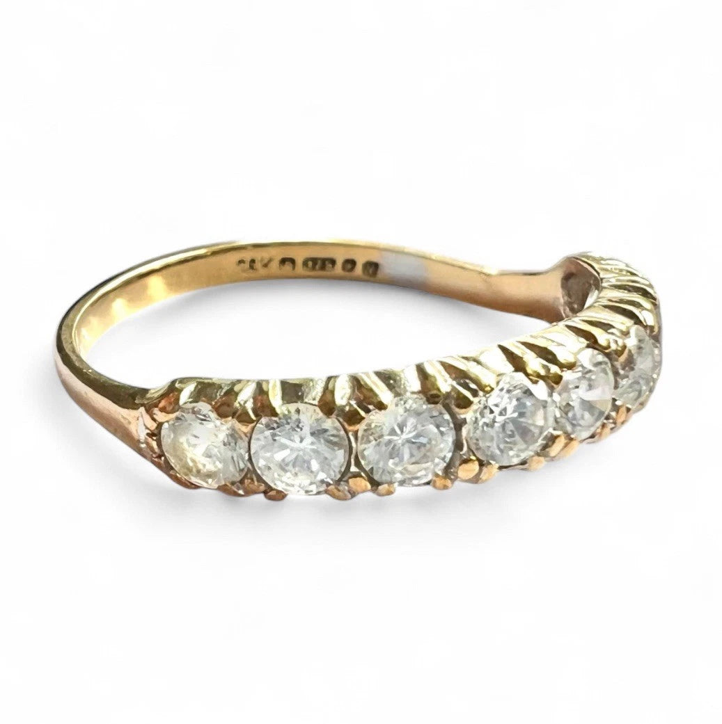 Gold ring with cubic zirconia on a white background