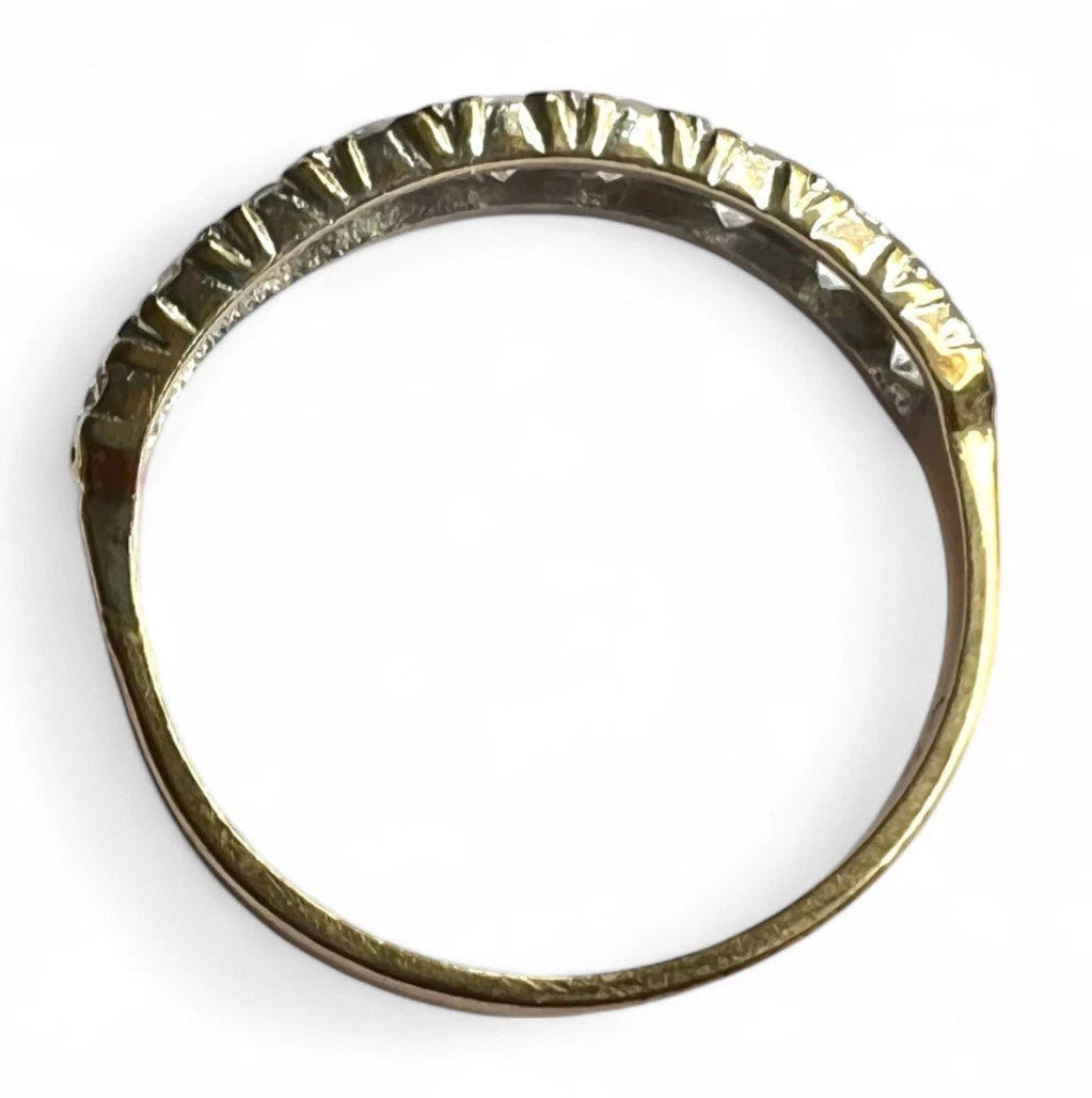 Gold ring with a cubic zirconia on a white background