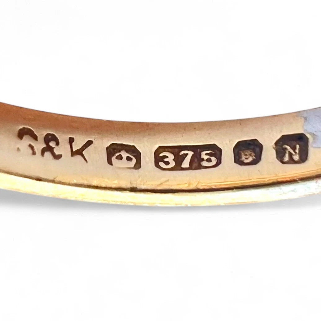 Gold ring hallmark close up on a white background