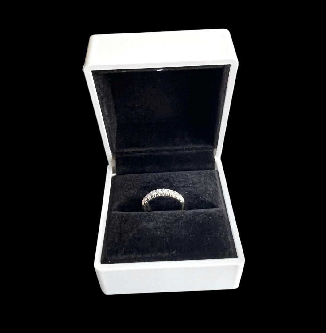 Gold Cubic Zirconia nine stone ring in a white box with a black interior