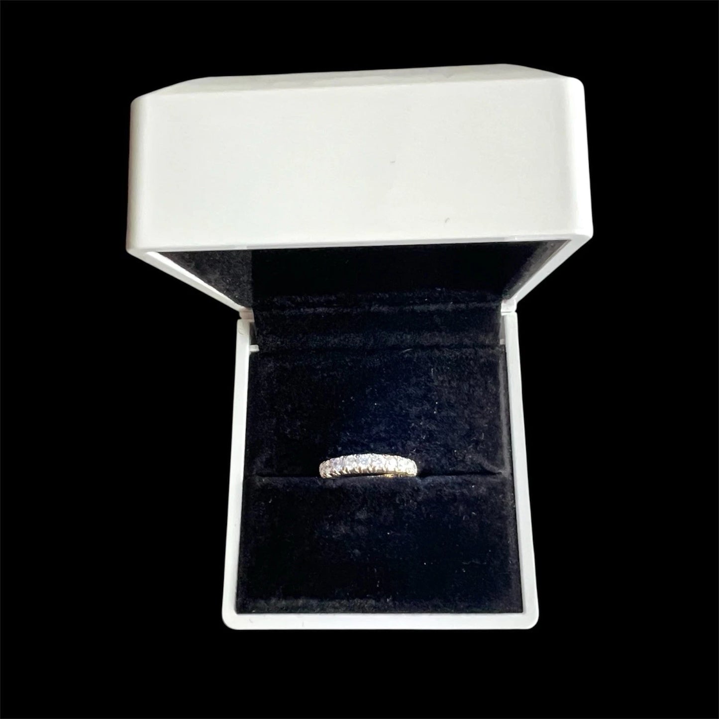 Nine Stone Cubic Zirconia ring in a white box with a black interior