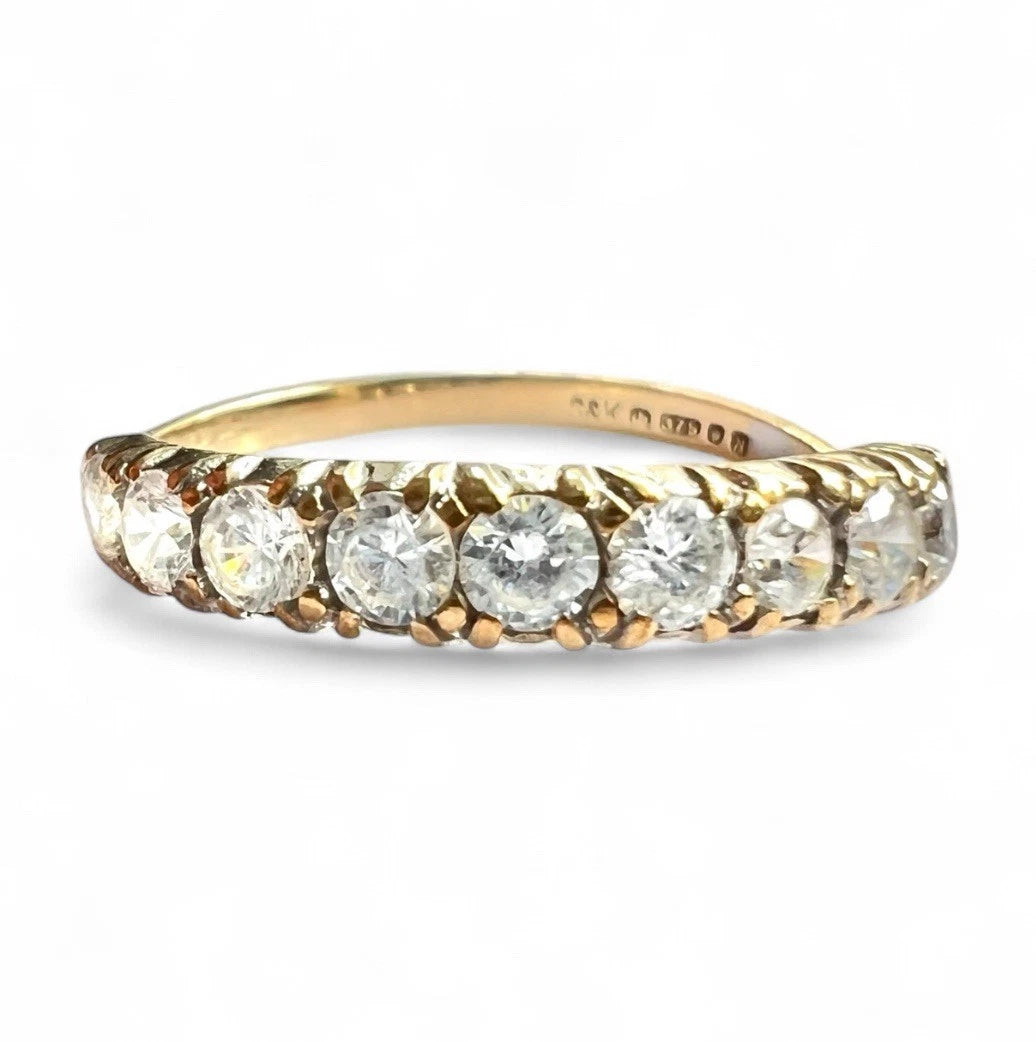 Gold ring with cubic zirconia on a white background
