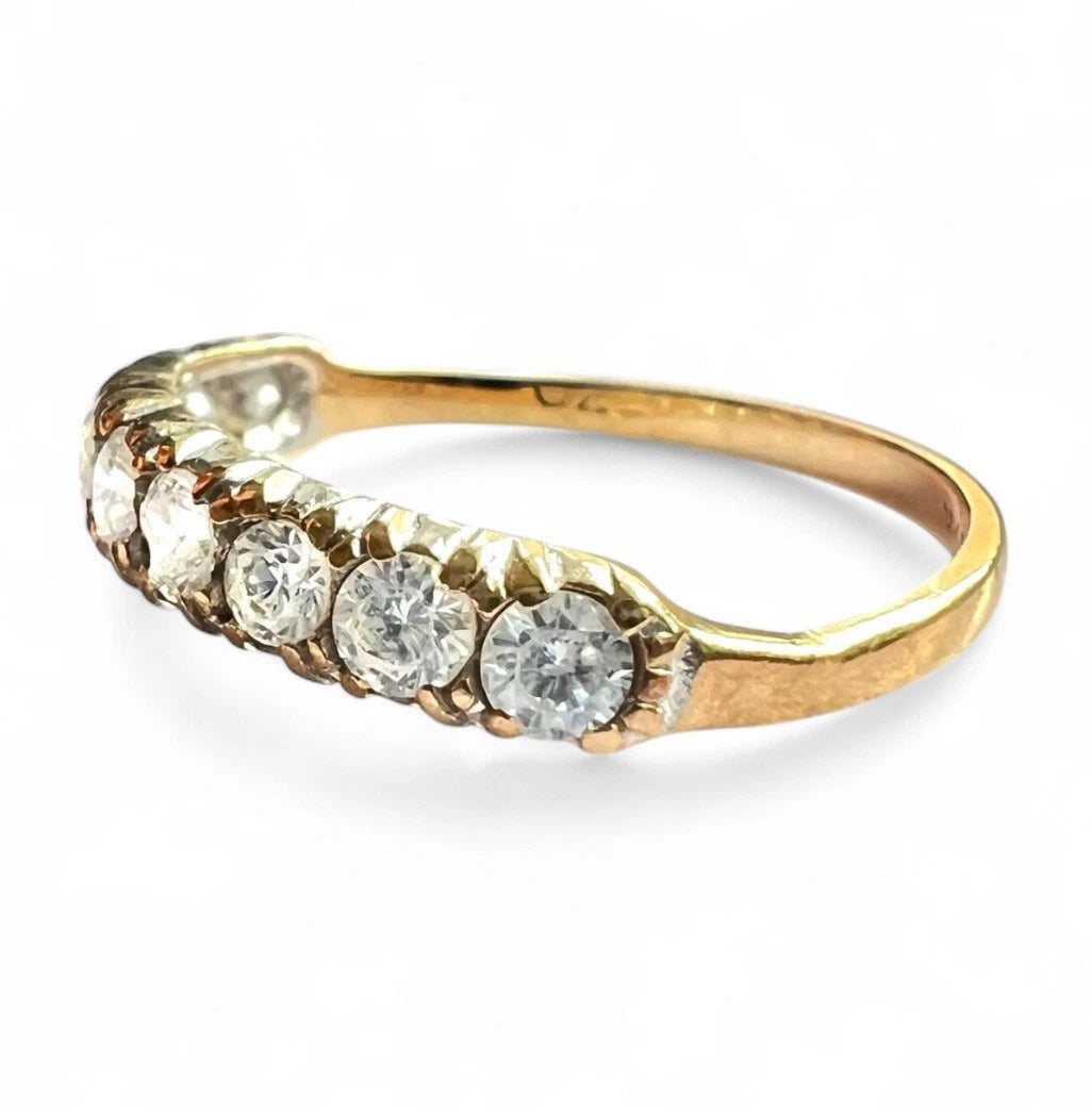 Gold ring with cubic zirconia on a white background
