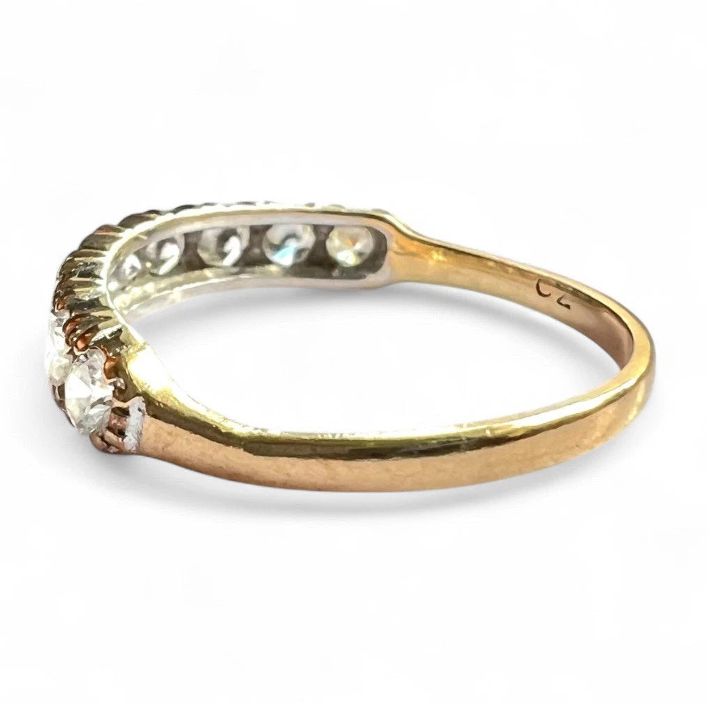 Gold ring with cubic zirconia on a white background