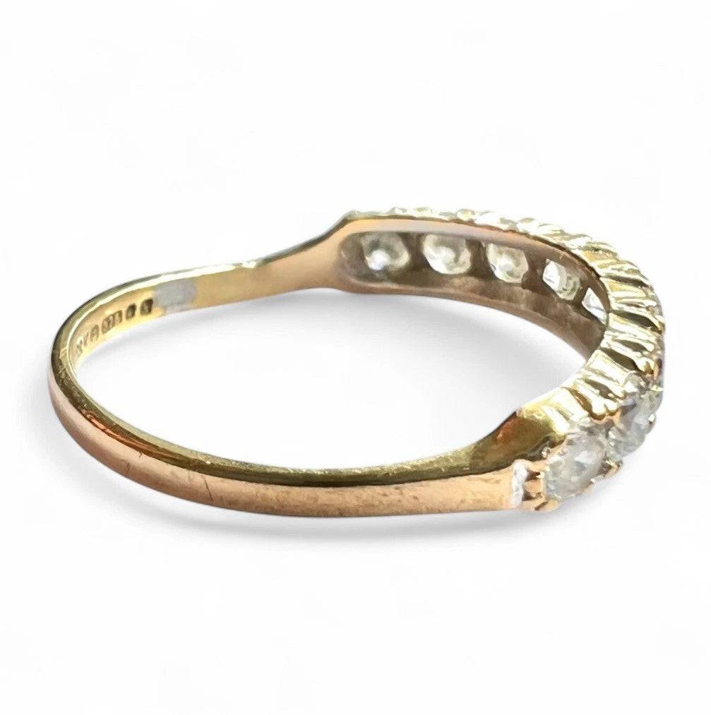 Gold ring with cubic zirconia on a white background