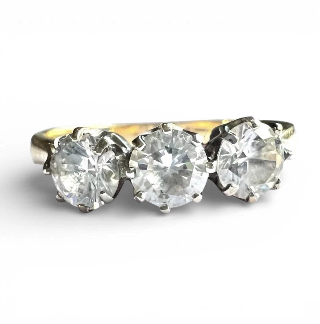Three-stone cubic zirconia ring on a white background close up front view 