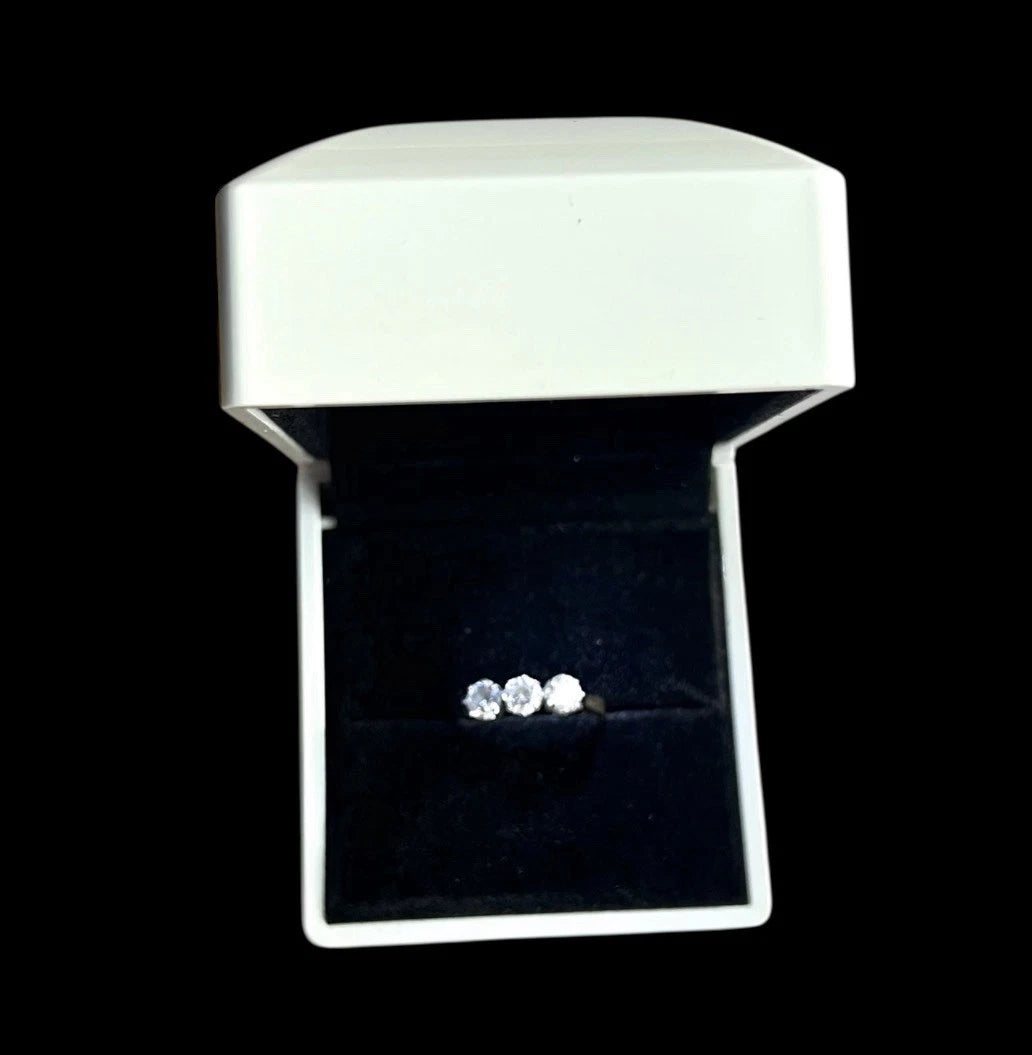 Cubic zirconia ring in a white jewellery box on a black background