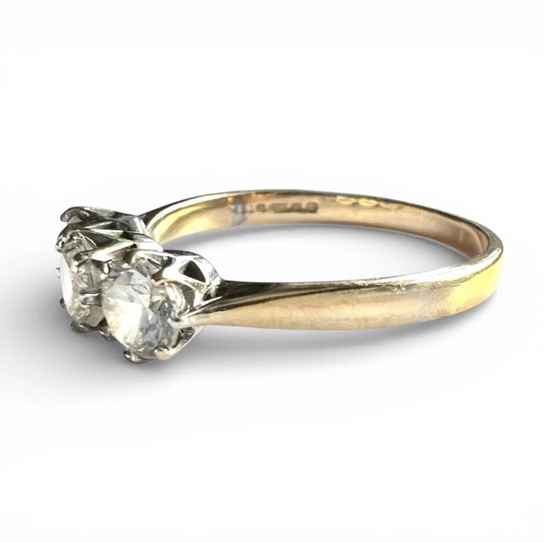 Gold ring with a diamond on a white background close up side view 