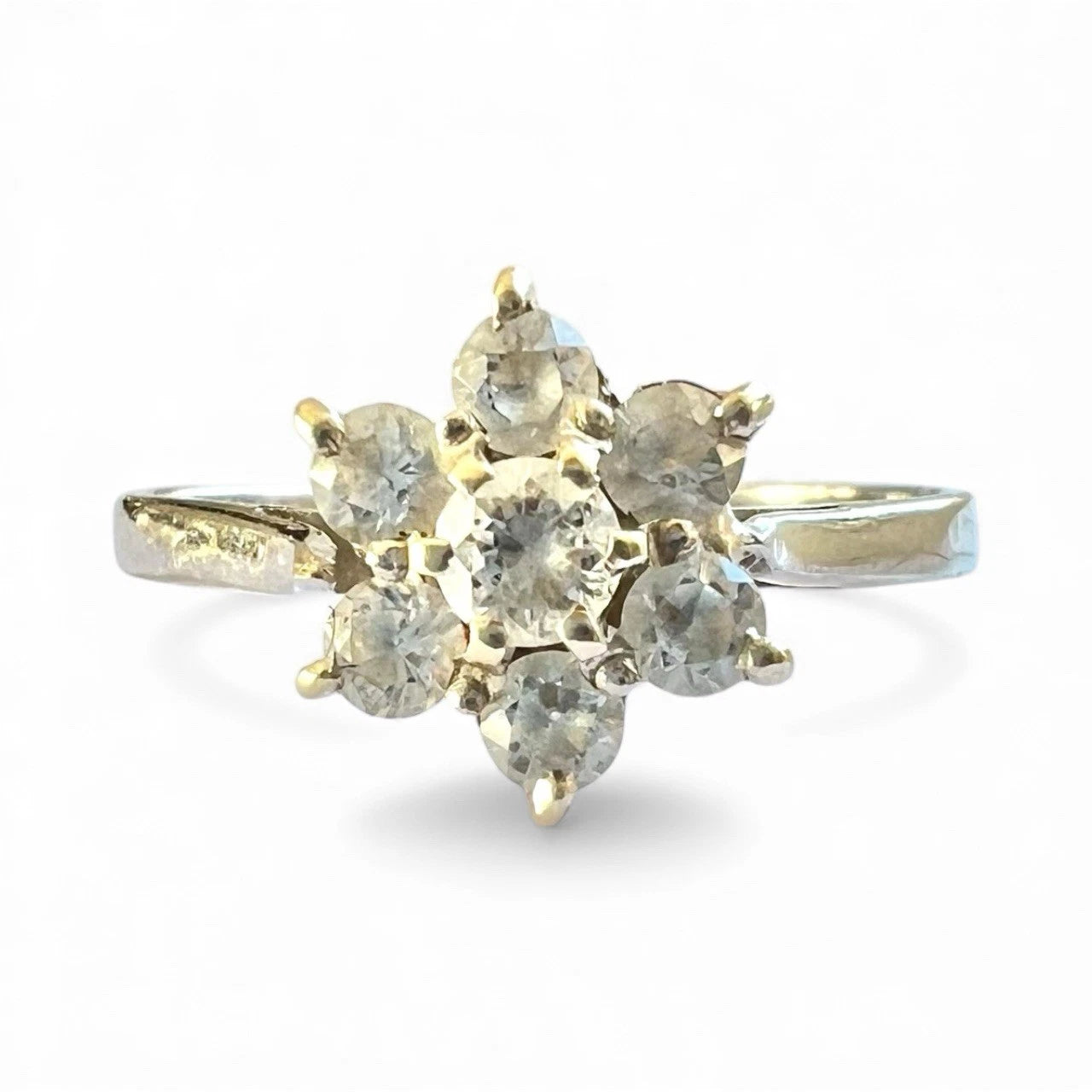 White Gold ring with cubic zirconia flower cluster on a white background