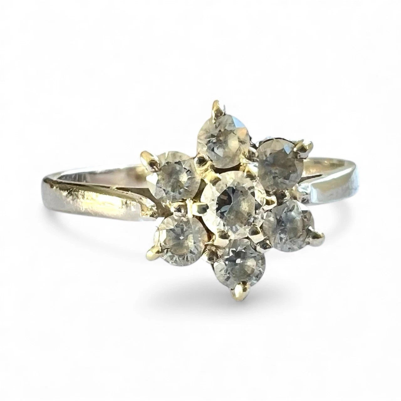 White gold ring with multiple gemstones on a white background