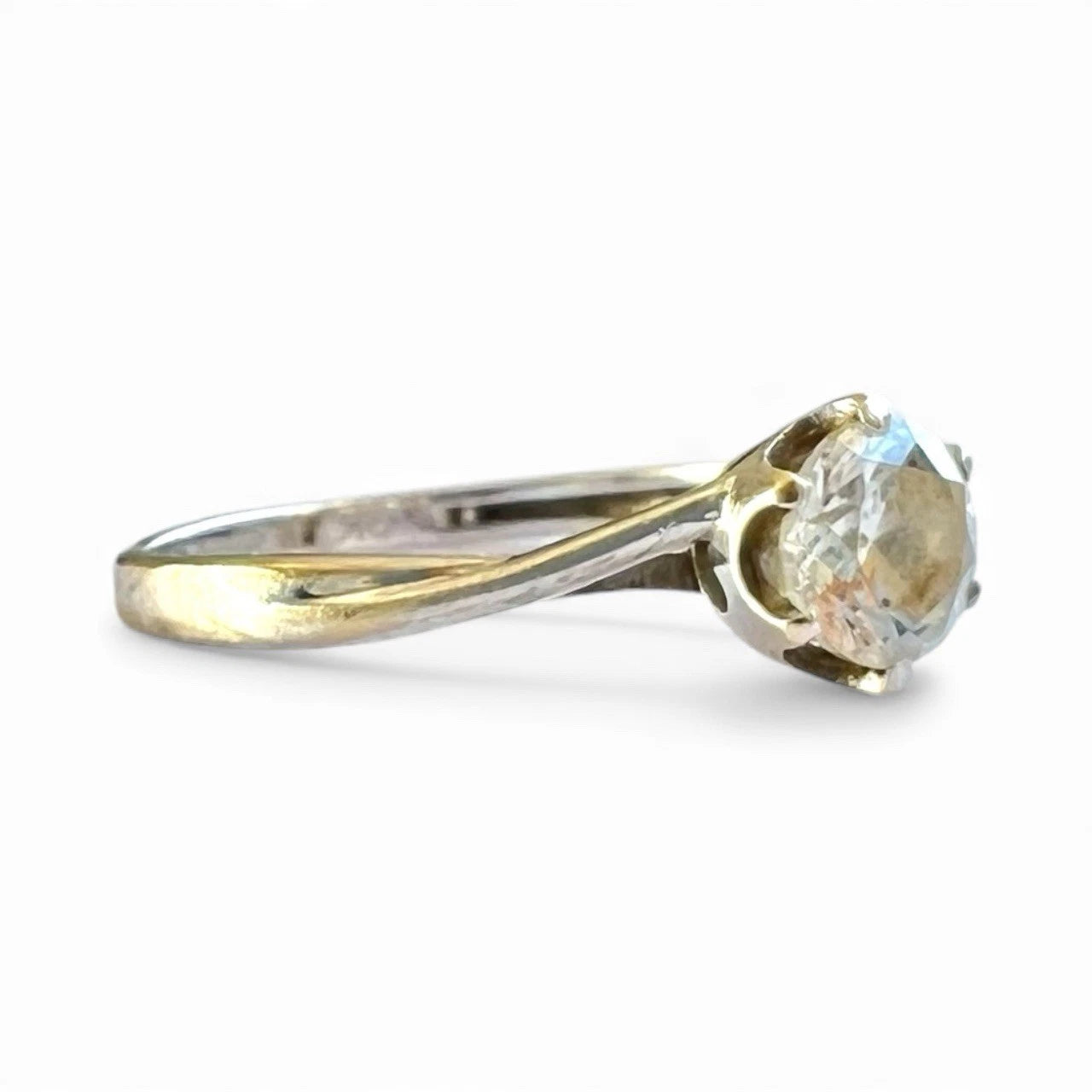 White Gold ring with a cubic zirconia on a white background close up side view of setting 