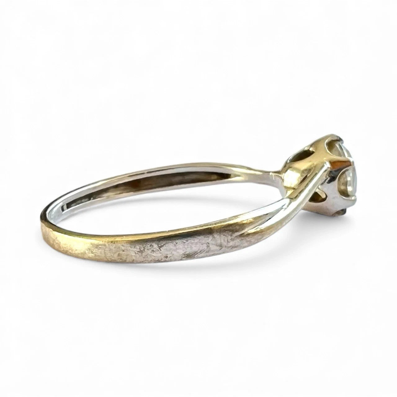 Vintage white gold ring on a white background, side view close up of setting and band 