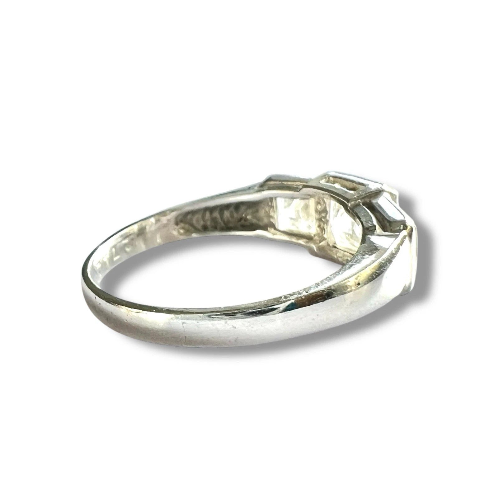 White gold ring with CZ on a white background, close up side view 