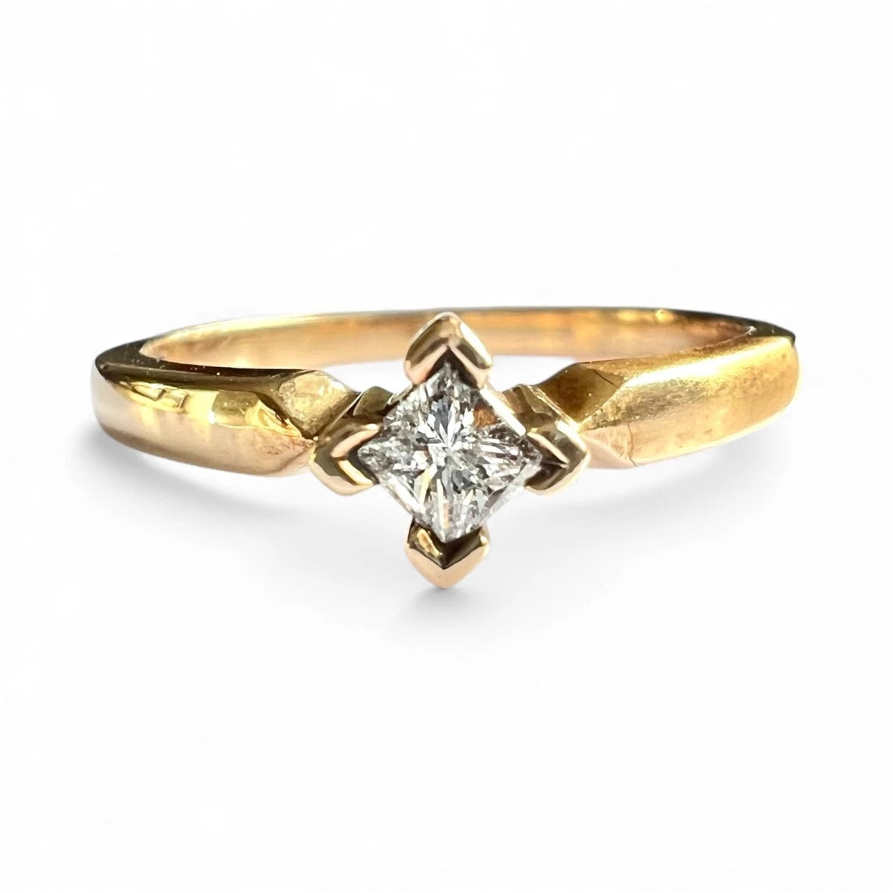 Gold ring with a diamond on a white background. Front Close up 