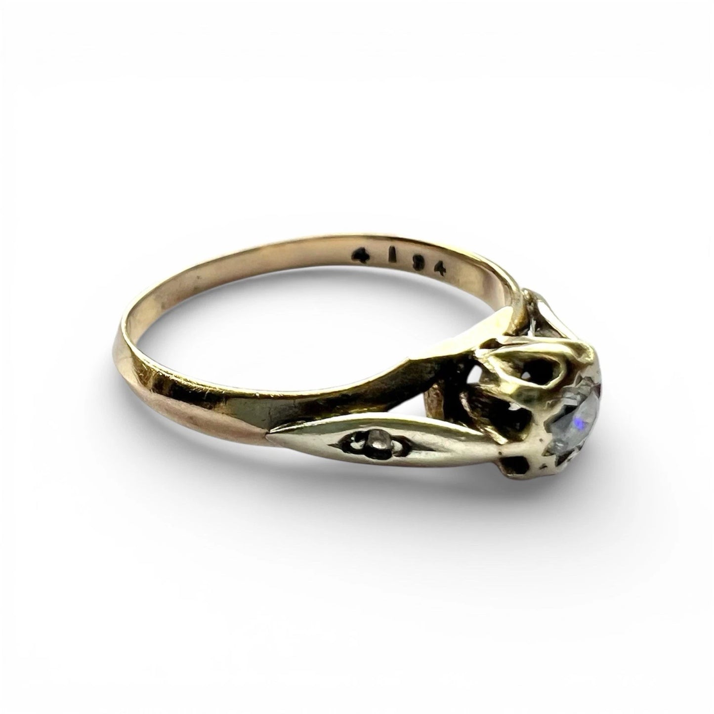 Gold ring with a diamond on a white background close up 