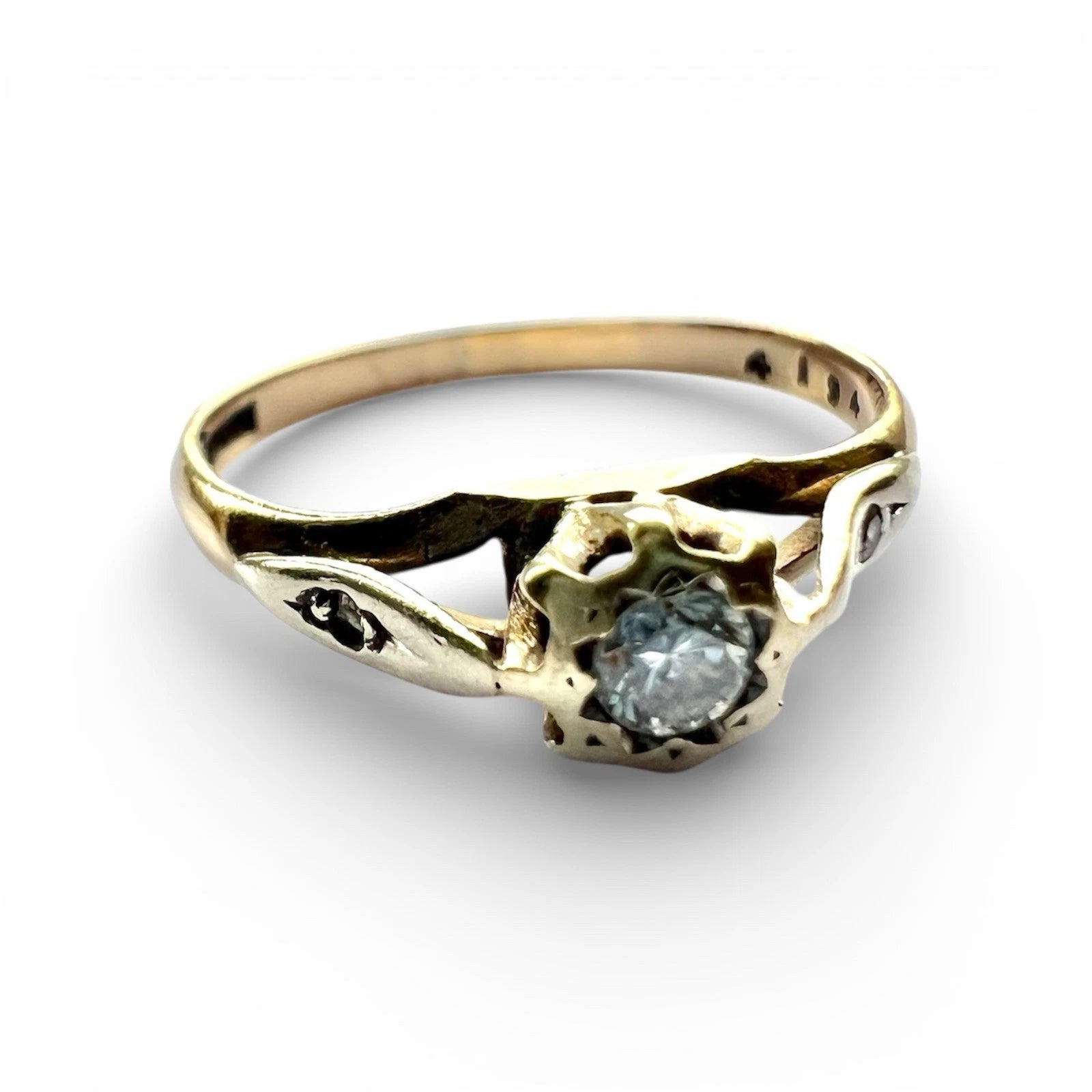 Gold ring with a diamond on a white background close up 