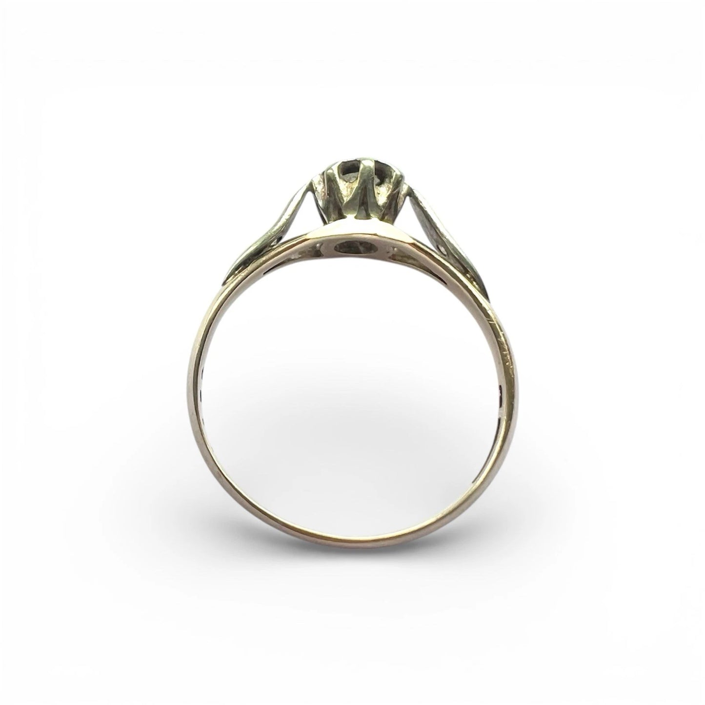 Gold ring with a diamond on a white background top down view 