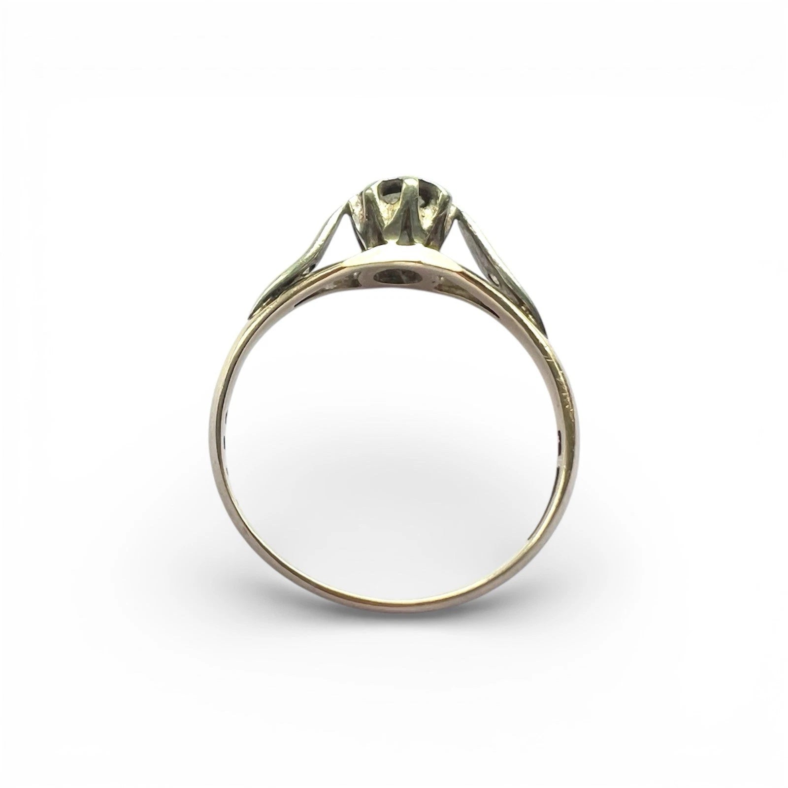 Gold ring with a diamond on a white background top down view 